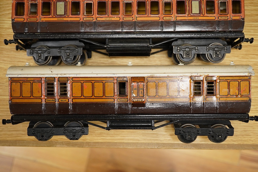 Three Carette for Bassett-Lowke 0 gauge railway 1921 series tinplate LSWR bogie coaches fitted with Bing couplings; two First Third Composite coaches, both 1328, and a full brake van, 133, all in salmon and chocolate liv